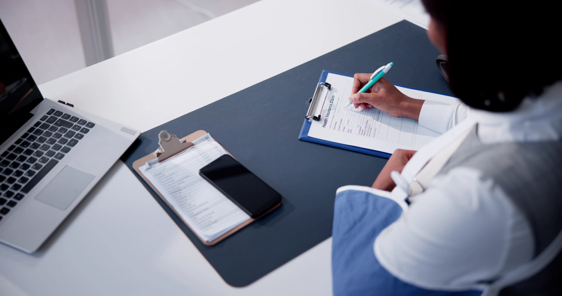 Person filling out health insurance claim.