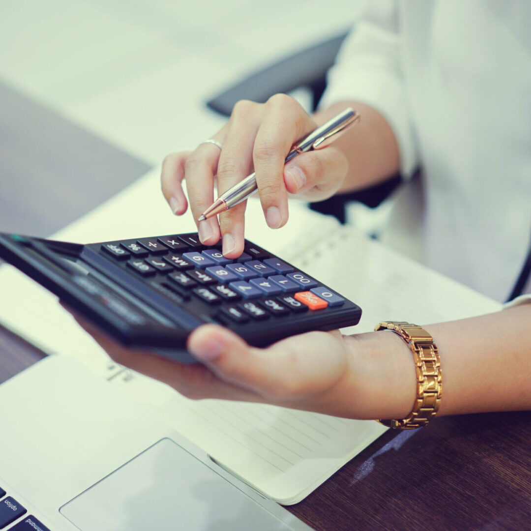 Woman using calculator and pen.